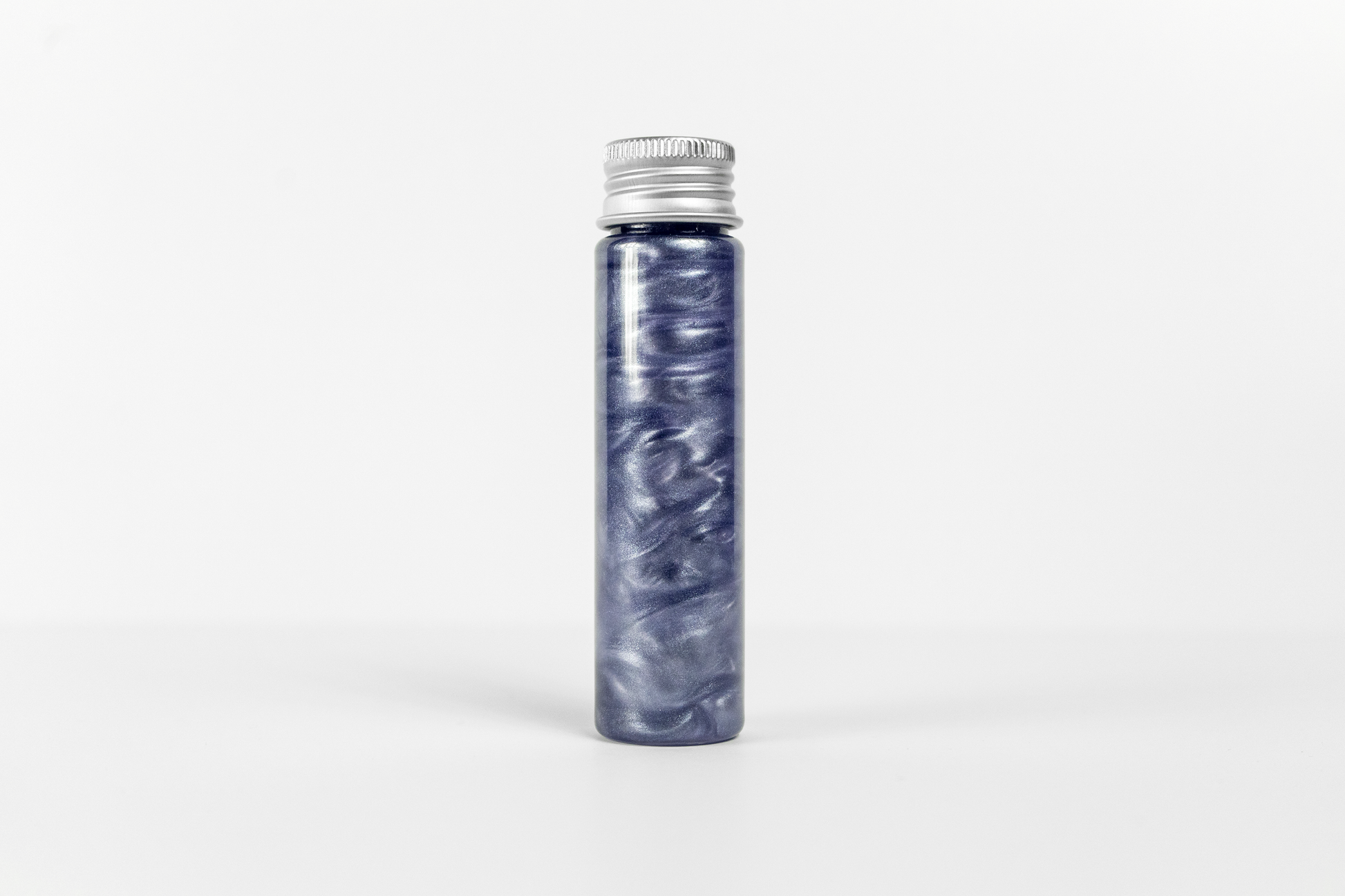 A cylindrical bottle with metallic blue swirling rheoscopic fluid inside, capped with a metal screw-on lid, against a white background.